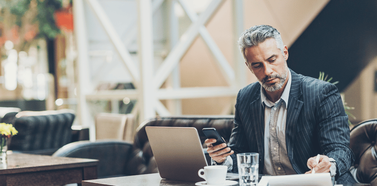 image of business man working in lobby evoking CFOs realize cost savings