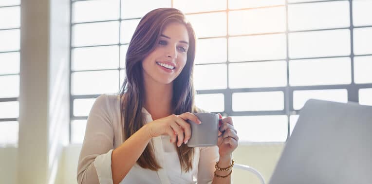 business woman in front of laptop evoking HR leaders Leverage Automation