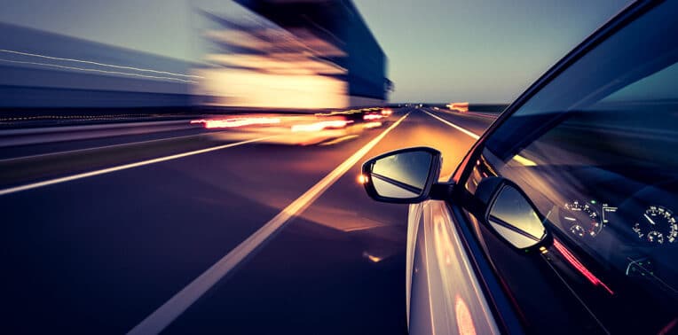 car speeding down road evoking driver safety program