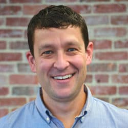 Man's headshot with brick background