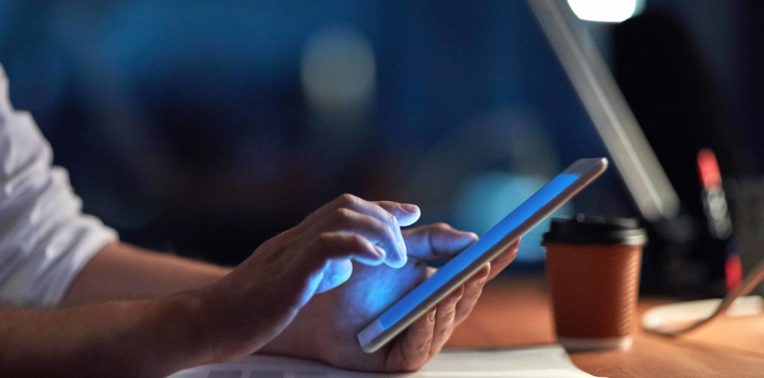 man on phone in office evoking Bring Your Own Device Guidelines