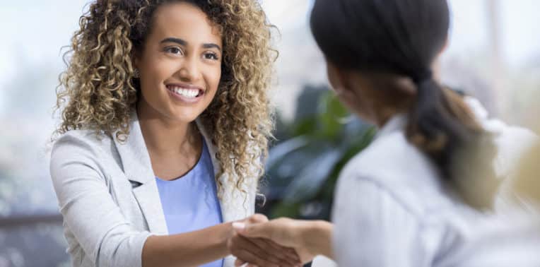 Woman shaking another person's hand