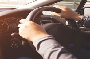 Hands on a steering wheel