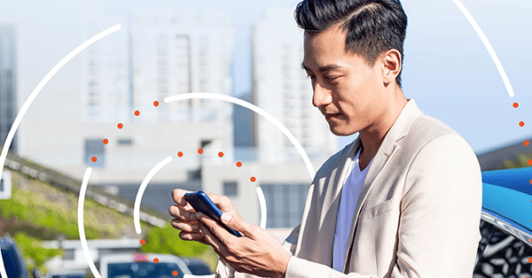 Man looking at a cell phone with white circles rippling out from him