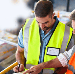 Man in a reflective vest looking down at something in another person's hand