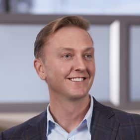 Headshot of a man with a window in the background