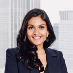 Headshot of a woman with a skyscraper in the background