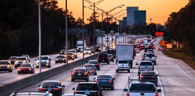 vehicles driving down highway evoking cost of mileage reimbursement