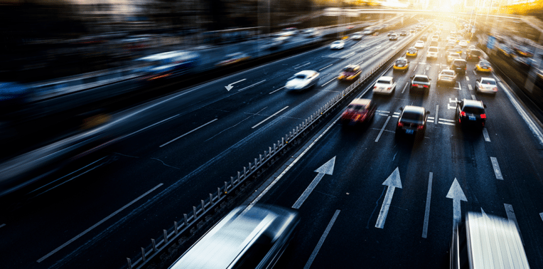 vehicles driving down road evoking company mileage reimbursement
