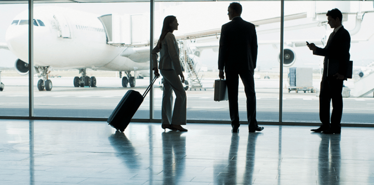 group of business travelers in airport evoking corporate travel