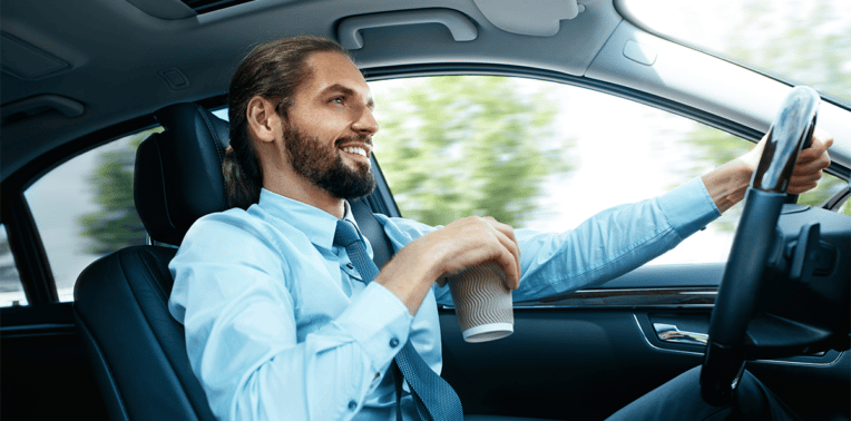 image of man in business attire at the wheel of a car evoking What is the National Average for Mileage Reimbursement?