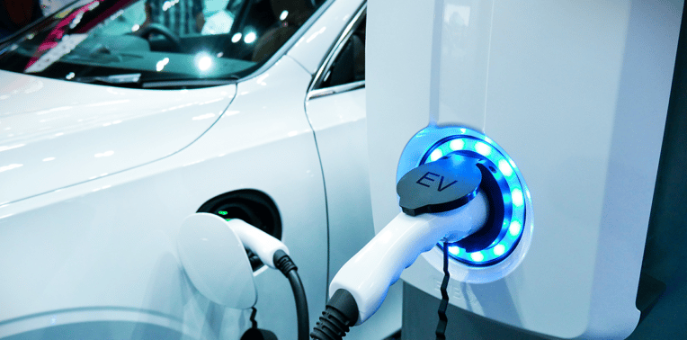 electric vehicle at charging station evoking EV incentives