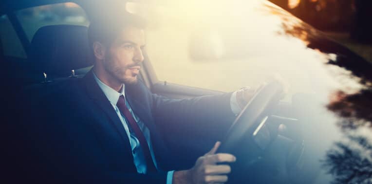 business man driving a car evoking IRS publication 463