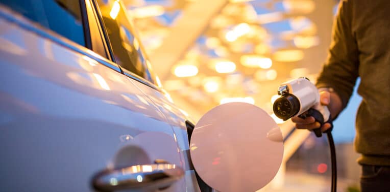 man charging his electric car evoking ev rates