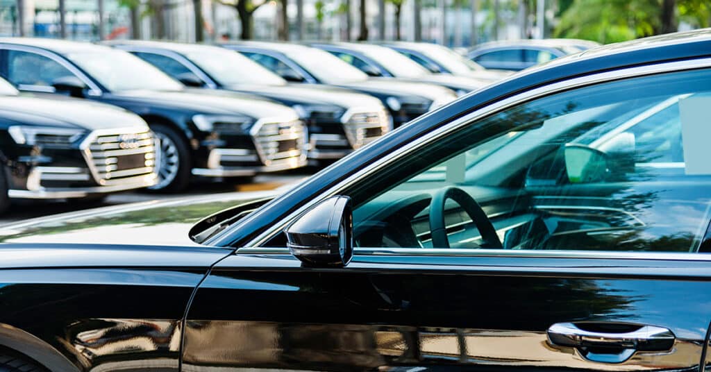 identical vehicles in a parking lot evoking Company-Provided Vehicles