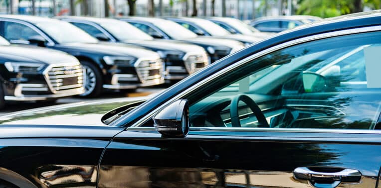 identical vehicles in a parking lot evoking Company-Provided Vehicles