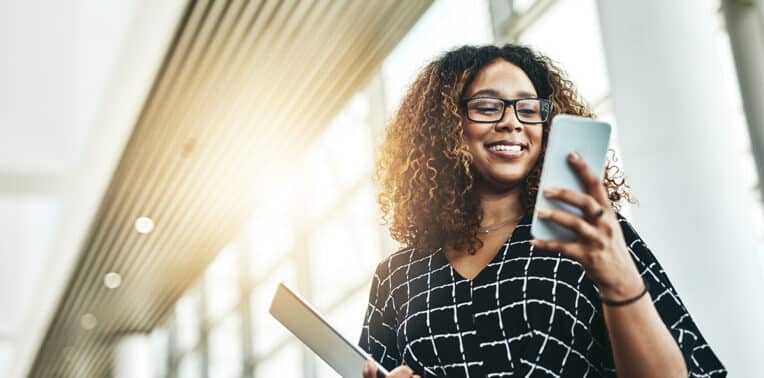 business woman with phone evoking how to choose an MMS provider