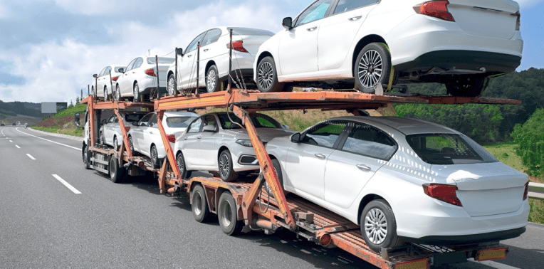 image of cars being transported evoking fleet vehicle disposal