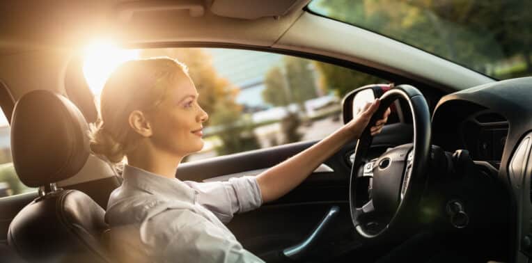 A Businesswoman in her car driving