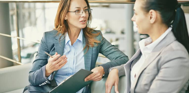 Image of two women having a discussion asking Questions <a href=